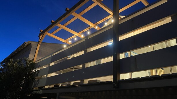 A multi-story building with a flat roof and large windows. - Authentic wooden chalet with sea view sleeps 4 (Gruissan)