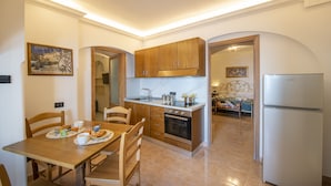 A modern kitchen with wooden cabinets, a built-in oven, and a refrigerator.