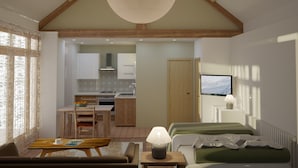Un intérieur moderne comprenant un coin repas, une kitchenette et un espace de vie avec un lit et un téléviseur.