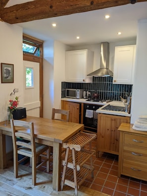 Enjoy cooking in this well-equipped kitchen with an oven, microwave, and stainless steel range hood.