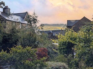Experience the tranquility of a traditional village amidst lush gardens and rolling hills.