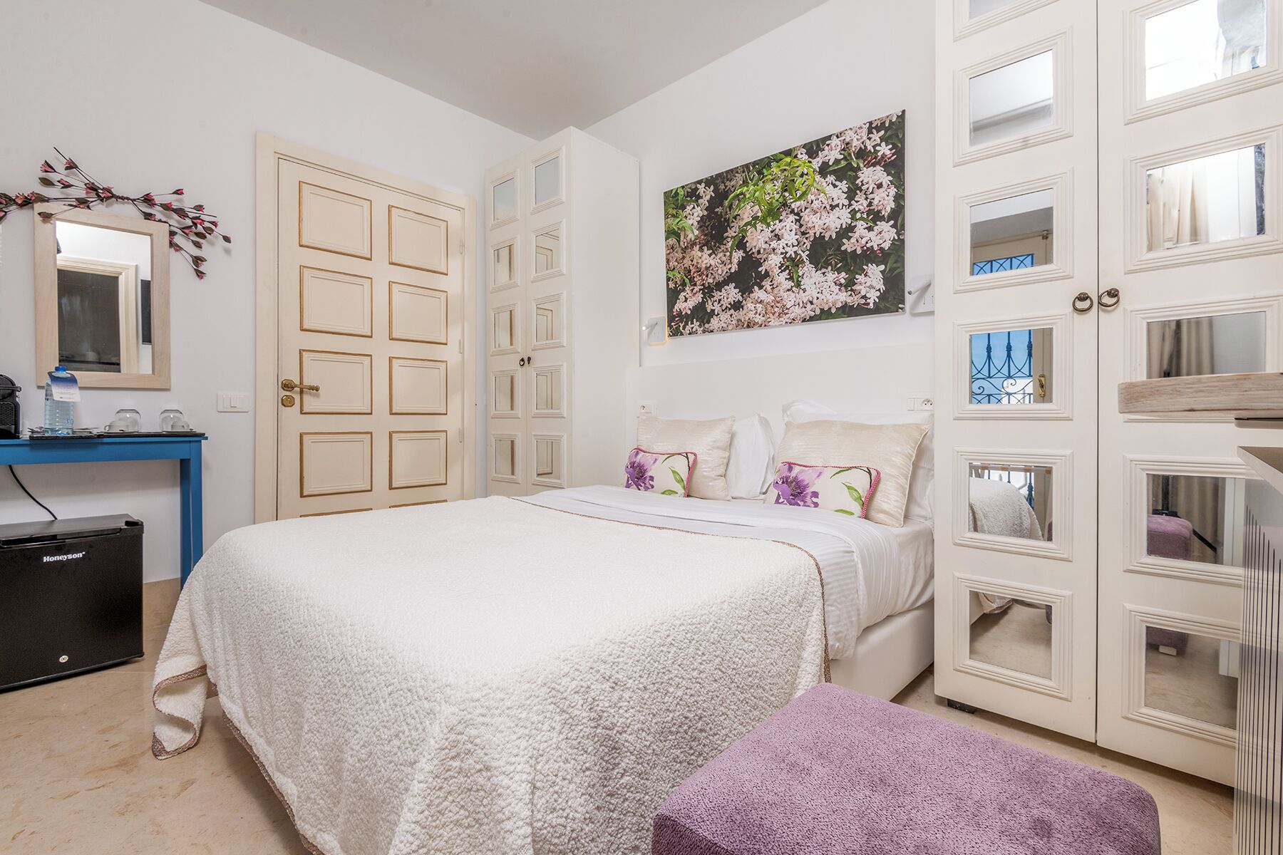 A bedroom with a bed, a desk, a chair, and a wardrobe.