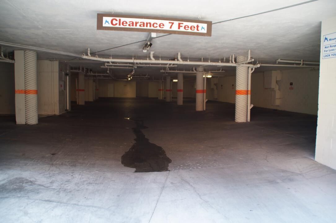 A parking garage with a sign indicating a clearance of 7 feet.