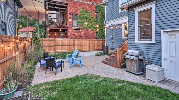 A backyard patio with outdoor furniture, a barbecue grill, and string lights. - Milwaukee Home < Half Mi to Lake Michigan! (Milwaukee)