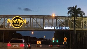 A Hard Rock Stadium sign above a road with vehicles. - Beautiful 2 bedroom house walking distance from hard rock stadium (Miami Gardens)
