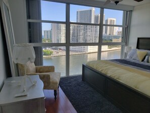 Enjoy a city view from the large window, with a bed and comfortable seating area.