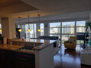 Enjoy a comfortable stay in this well-appointed living space with a central kitchen island, dining area, and cozy seating area.