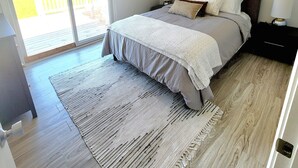 A bedroom with a bed, a ceiling fan, a window, and a view of the outdoors. - WATERFRONT!! **HOT TUB**  3 bedroom Oasis on 2+ acres - Sleeps 8 (Cambridge)