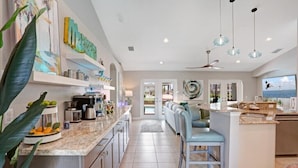 A modern kitchen with granite countertops, stainless steel appliances, and a central island with bar seating.