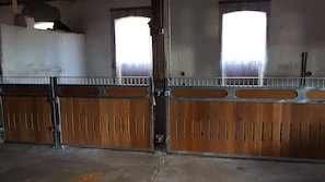 Stable features two large gates with metal latches and wooden slats.