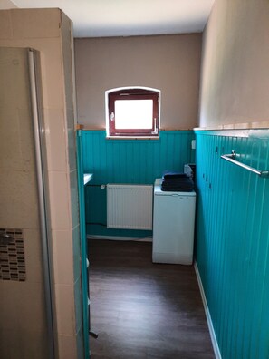 Bathroom features a white sink, toilet, and radiator.