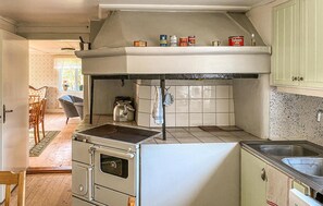 Functional kitchen with a large stove, sink, and ample storage for cooking essentials.