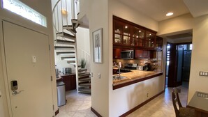 A modern kitchen with a central island, stainless steel appliances, and wooden cabinets. - Luxurious • Upscale • Open Concept • Elegant • Beautifully Maintained (Huntington Beach)