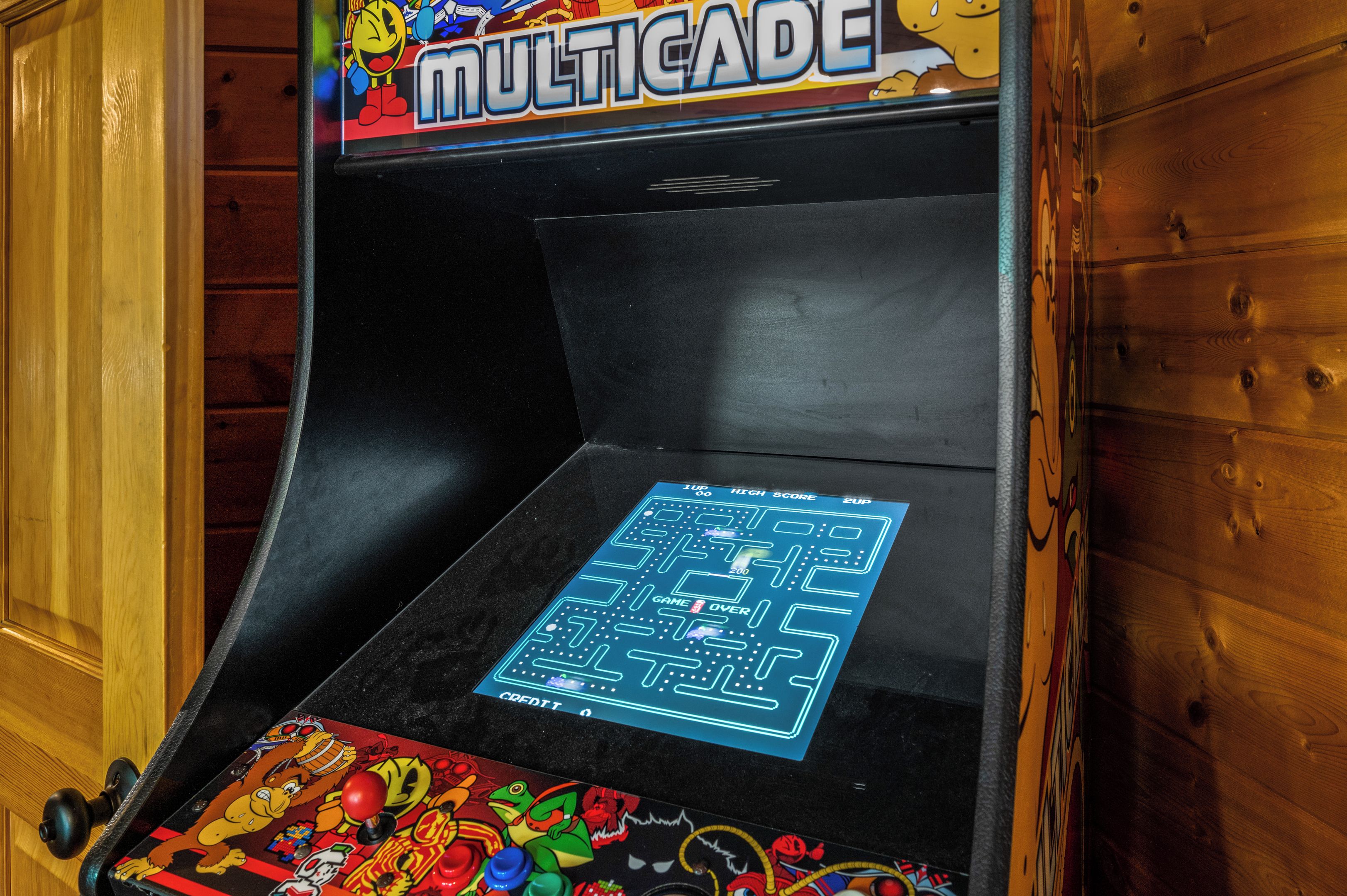 A video game arcade machine with a colorful display and joystick.
