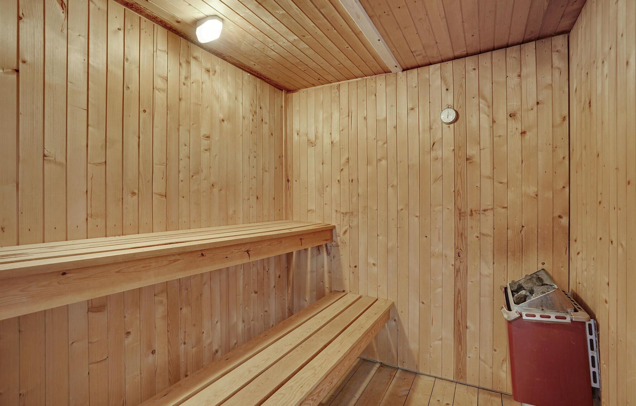 A sauna with wooden walls and benches.