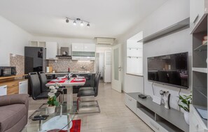 Relax in this stylish apartment with a comfortable sofa, TV, and dining area, plus a fully equipped kitchen and balcony.