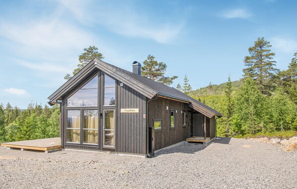 A wooden cabin with a large glass window, a wooden deck, and a sign that reads "Saalstuben". - Awesome home in Rena with WiFi (Rena)