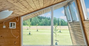 A room with a large window offering a view of a grassy field and trees. - 1 bedroom pet friendly home in Kolding (Kolding)