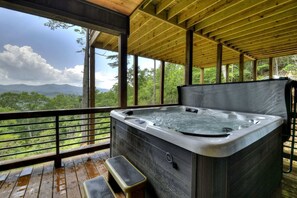 A hot tub on a wooden deck with a view of mountains and trees. - Gem of Blue Ridge | Pool + Views + Hot Tub (Blue Ridge)