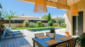 A patio with a pool, outdoor seating, and a view of the neighborhood. - Beautiful home in Robion (Robion)