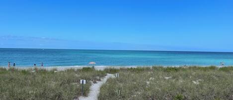 Rannalla, aurinkotuoleja, rantapyyhkeitä