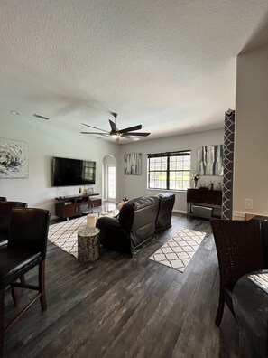 Relax in style with a comfortable seating area, large flat-screen TV, and a beautiful view.