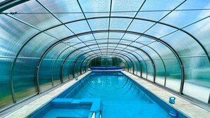 A transparent tunnel-like structure with a pool inside. - *PRIVATE LEISURE POOL* 3bd 2ba Home Near Bypass&Amenities (Kalispell)