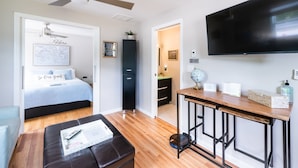 A modern hotel room with a bed, a desk, a television, and a ceiling fan. - 2 Charleston's Charm Studio 2 is a Private studio 4 miles to Downtown Charleston (Charleston)