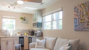A modern kitchen with a dining area, a ceiling fan, and a large window. - 2 Charleston's Charm Studio 2 is a Private studio 4 miles to Downtown Charleston (Charleston)
