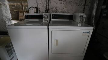 A pair of stacked front-loading washers in a utility room.
