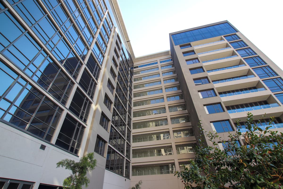 A high-rise building with multiple floors, large windows, and a modern architectural design.