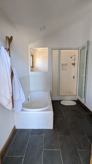 Bathtub, towels, soap, toilet paper
