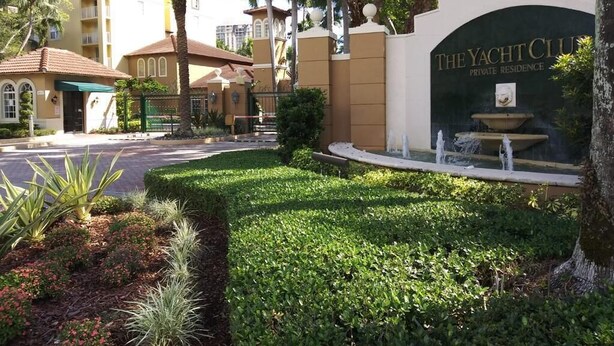 A gated entrance to The Yacht Club Private Residence with a fountain and landscaped garden. - Modern cozy feeling Next to Beach and Aventura Mall (Miami)