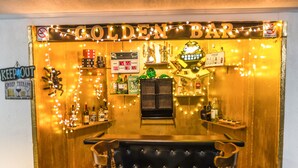 A bar area with a sign reading "Golden Bar," shelves with bottles, a jukebox, and a neon sign. - Pocono Escape with huge Pool HOT TUB,GAMEROOM,FIREPIT,near Camelback & Kalahari (Stroudsburg)