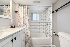 Bathtub, hair dryer, towels, soap