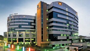 A modern building with two main structures, one with a visible sign reading "BLK-MAX". - Hotel Admire Inn Sector-51 by ASPL (Noida)
