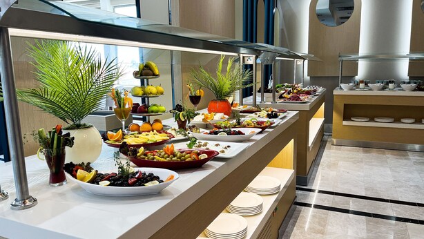 A buffet with various food items and a fruit display. - The Sign Degirmen Hotel & Spa (Sile)