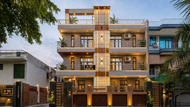 A multi-story residential building with a modern design, featuring balconies, large windows, and a gated entrance. - Hotel Diamond Stay by ASPL (Noida)