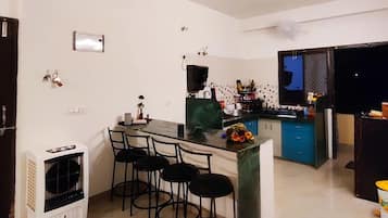 Fridge, microwave, cookware/dishes/utensils, dining tables