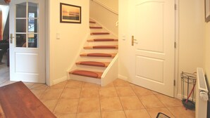Eine Treppe mit Holzsitzen und einer weißen Tür am oberen Ende.