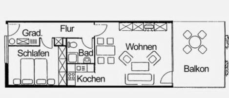 Un plan d’étage comprenant un salon, une cuisine, une salle de bain et un balcon.