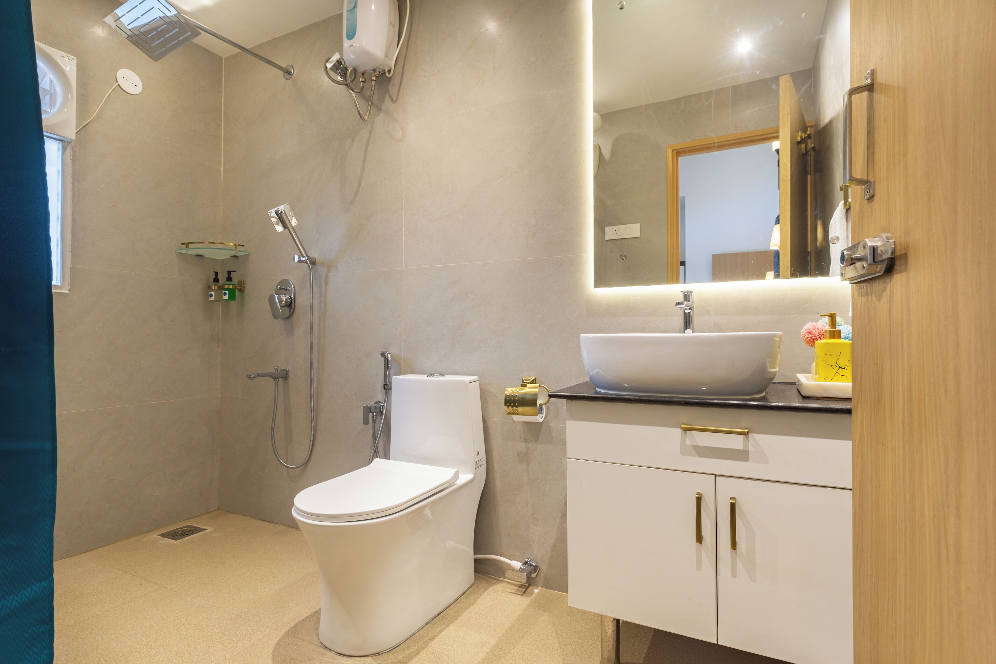 A modern bathroom with a toilet, shower, and sink.