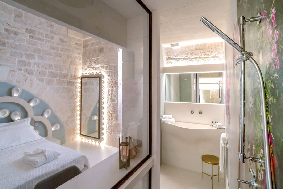 A modern bathroom with a shower, sink, and mirror.