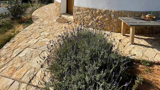 A white building with a stone base, a wooden door, and a small window. - Beautiful mill and views, in the hinterland of the Algarve coast line.<br> (Alcantarilha)