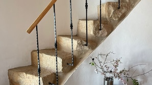 A stone staircase with a wooden handrail and black metal balusters. - Beautiful mill and views, in the hinterland of the Algarve coast line.<br> (Alcantarilha)