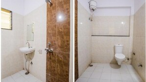 A bathroom with a sink, mirror, and toilet. - Mgh 114 Hotel Krishna Udaipur (Udaipur)