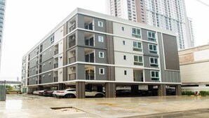 A multi-story residential building with balconies, a parking garage, and a modern architectural design. - Zayn Express & Suites (Bangkok)