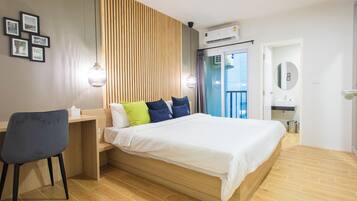 Relax in a spacious room with a large bed, desk, and seating area.