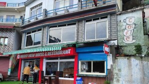 A two-story building with a restaurant on the ground floor. - Valley View Inn (Nainital)