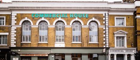 A building with a sign reading "COMMERCIAL HOUSE" above the entrance.